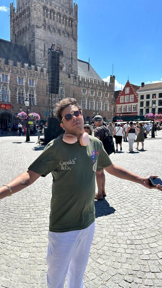Jai Agarwal with arms outstretched in the Markt square in Bruges
