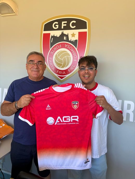 Jai Agarwal and a club official holding up the red Guarda FC shirt in front of the crest
