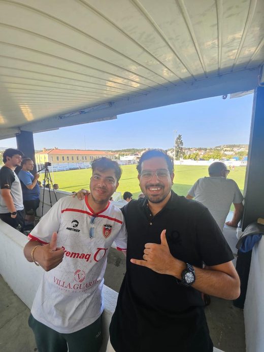 Jai Agarwal in the white Guarda FC shirt giving a thumbs up from the covered stand